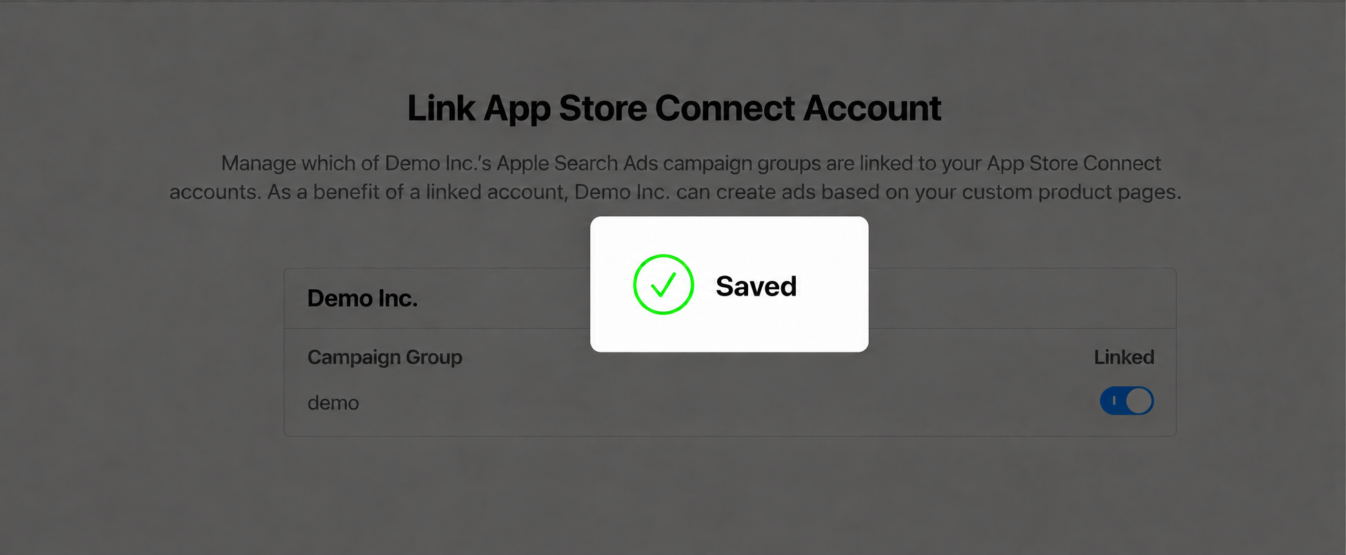 Apple Ads shows Saved with a green checkmark after the Linked switch is turned on.